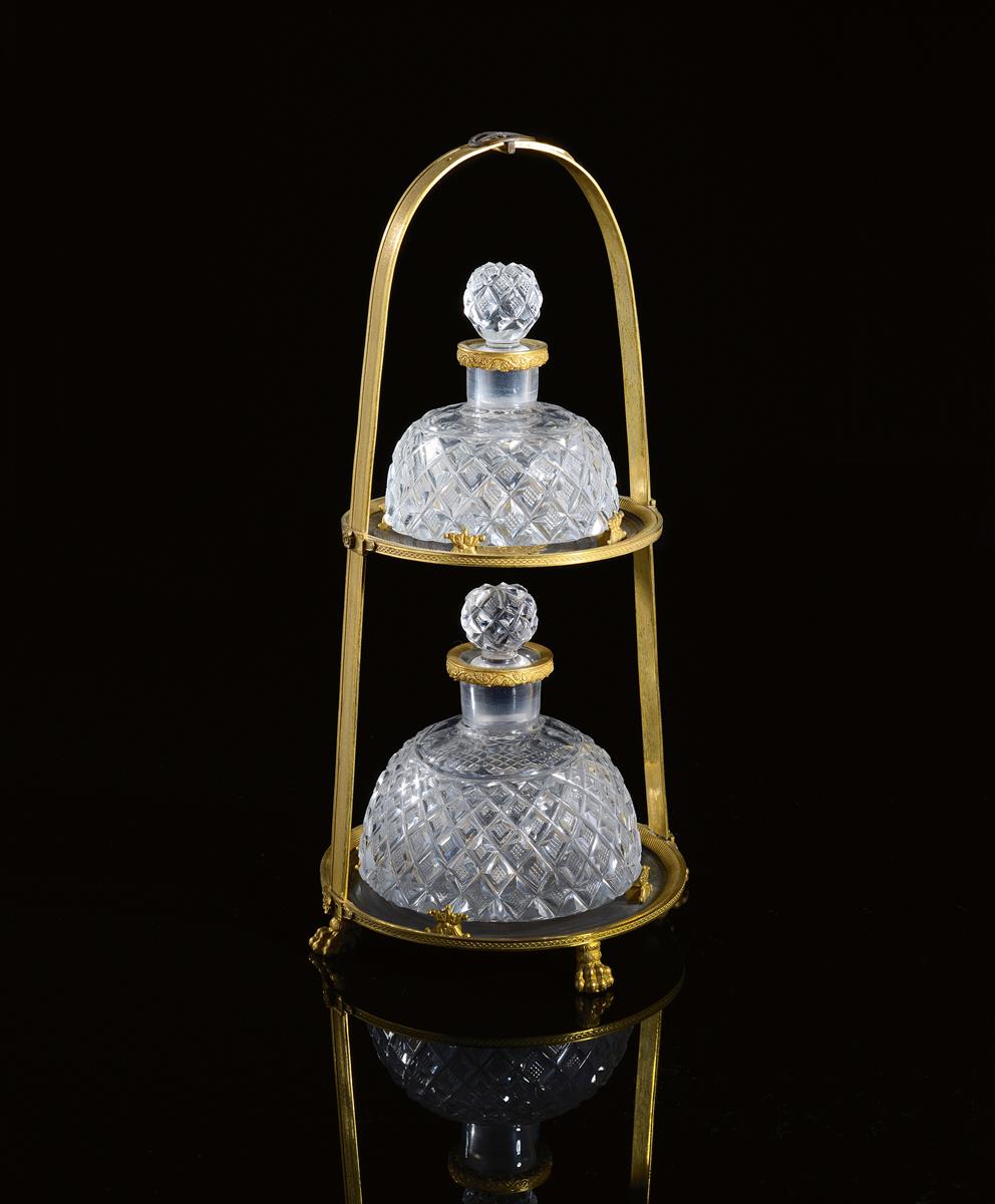 A Restauration ormolu scent bottle stand, in the form of a stirrup, the top with a buckle above