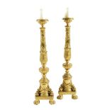 A pair of Italian giltwood altar style pricket candlesticks, with a leaf and flower column stem, the