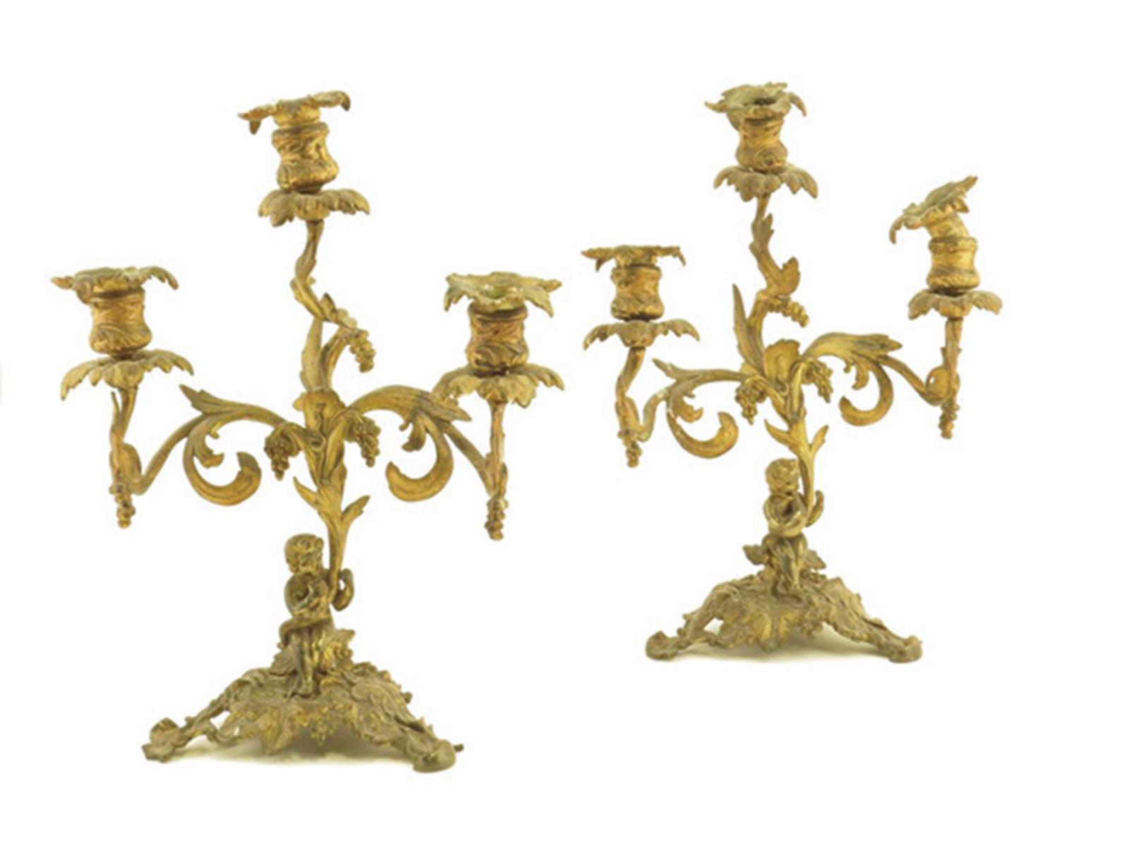 A pair of 19th century ormolu candelabra, with four leaf scroll branches issuing from a cornucopia