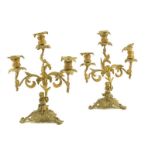 A pair of 19th century ormolu candelabra, with four leaf scroll branches issuing from a cornucopia