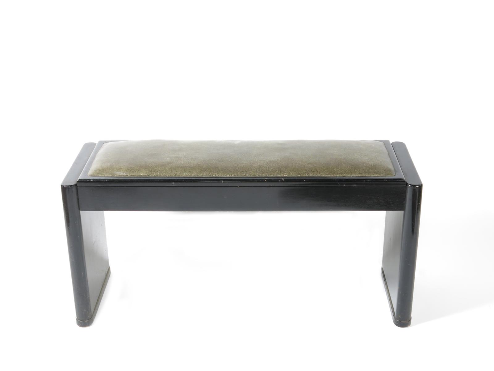 An ebonised wood piano stool,  double width, with hinged seat, the seat with faux shagreen covering,