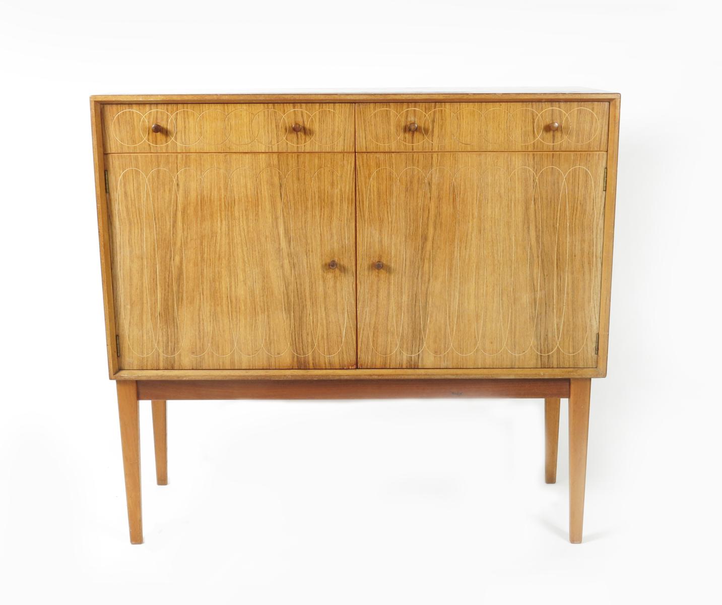 A Gordon Russell R411 two door birch sideboard designed by W.H Russell,   the cupboards and