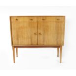 A Gordon Russell R411 two door birch sideboard designed by W.H Russell,   the cupboards and