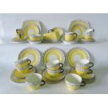 A quantity of Lawleys Foley china yellow ground tea wares with black printed swag detail