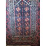 A Persian style red ground rug with small medallion detail, set within alternating borders, 135 x 85