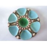 A 19th century Minton majolica oyster plate glazed in tones of turquoise, green and brown, with