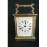 A French brass carriage clock by Duverday & Bloquel with enamel dial and 8 day timepiece