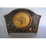 A small Edwardian lacquered mantle clock with chinoiserie style case and eight day time piece