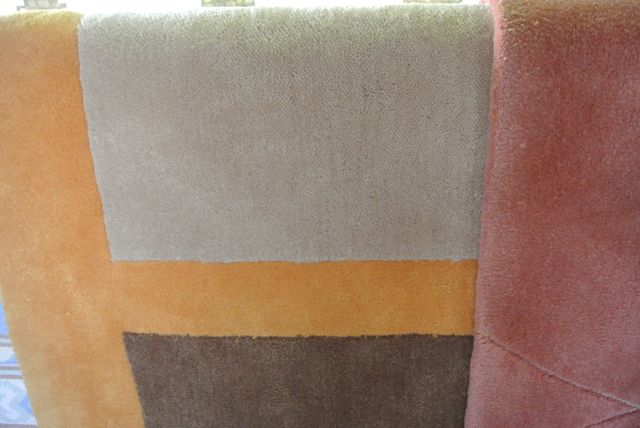 Two contemporary wool rugs, one in beige, chocolate and toffee colourway, 185 x 120, the second in