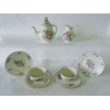 A collection of French Luneville tea wares with floral spray decoration comprising teapot, milk jug,