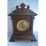 A late 19th century German mantle clock, the walnut case with applied and carved moulded detail,