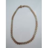 A 9ct tri-gold necklace, composed of textured brick-links, 18g