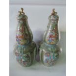 A pair of substantial 19th century double gourd shaped Cantonese vases and covers with reserved