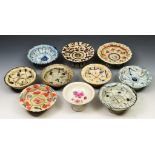 A collection of nine 19th century Chinese circular dishes raised on circular feet and produced for