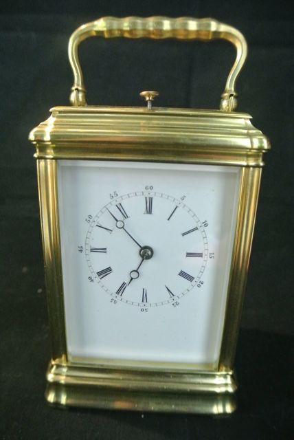 A French brass carriage clock set in a gorge case with 8 day striking movement on a bell by