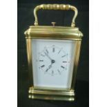 A French brass carriage clock set in a gorge case with 8 day striking movement on a bell by