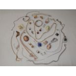 An iridescent crystal bead necklace; two faux cameo brooches; three strands of faux pearls; and a