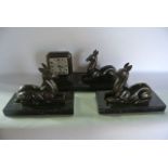 A French Art Deco clock garniture, a three piece marble based set supporting recumbent spelter