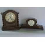 An Edwardian oak mantle clock with engine turned dial, the oak case with barley twist supports