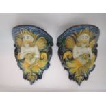 A pair of Cantagalli maiolica wall brackets with moulded satyr supports in yellow, blue, brown and