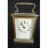 A brass carriage clock with enamel dial and 8 day timepiece