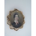 A mid Victorian portrait miniature brooch, of a young lady with white collar and pink bow, in an