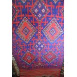 An eastern wool runner, predominantly in a blue and red colourway with geometric detail within
