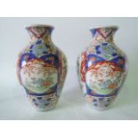 A pair of early 20th century Imari vases of shouldered form with landscape and bird decoration