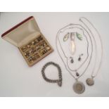 A gem-set demi-parure, comprising: a pendant on chain and a pair of stud earrings, each set with a