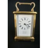 A French brass carriage clock with 8 enamel dial and 8 day time piece retailed by Furber & Son