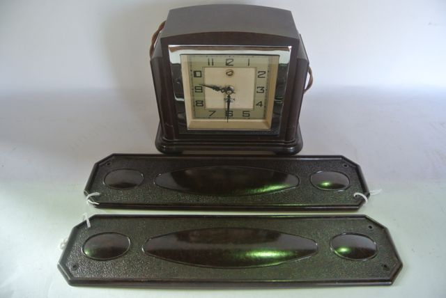 A dark brown Bakelite cased mantle clock in the Art Deco manner with symmetrical stepped frame,
