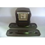 A dark brown Bakelite cased mantle clock in the Art Deco manner with symmetrical stepped frame,
