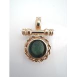 An intaglio pendant clasp, the green hardstone intaglio within a rope-twist border, flanked above