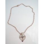 An Edwardian amethyst and seed pearl pendant, of circular open worked form, centred and hung with