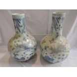 A pair of large Chinese vases with globular bodies and drawn necks, with blue and white painted