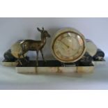 A high Art Deco French clock garniture in spelter and marble, the circular clock face supporting a