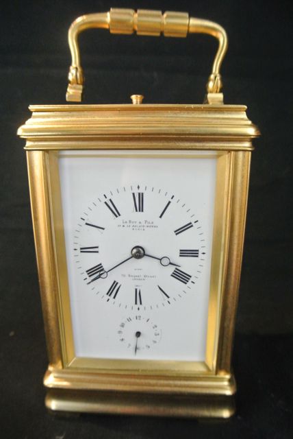 A French brass carriage clock set in a gorge case with 8 day striking movement with alarm and repeat