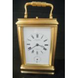 A French brass carriage clock set in a gorge case with 8 day striking movement with alarm and repeat