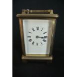 A French carriage clock with brass casework, enamel dial and 8 day timepiece.