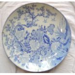 A large oriental charger with blue and white painted decoration of prunus blossom, pheasant, birds