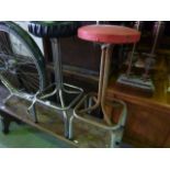 Two retro high stools with circular leatherette covered seats raised on tubular steel supports