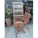 A contemporary hardwood steamer type chair with slatted seat and back together with four further