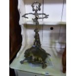 A decorative cast iron umbrella/stickstand with hanging game, rifle, horn and further detail