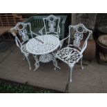 A decorative cast aluminium terrace table of circular form with decorative pierced circular