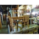 A contemporary pine kitchen table in the Victorian style, the rectangular top raised on four