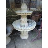 A composition stone sectional garden fountain with two shallow graduated circular bowls with