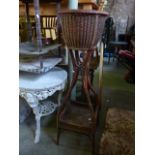 An unusual wicker jardiniere with shaped supports united by a square wooden under tier together with