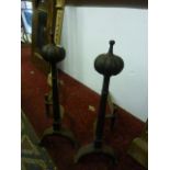 A pair of good quality cast iron andirons with tapered chamfered columns and fluted bun shaped