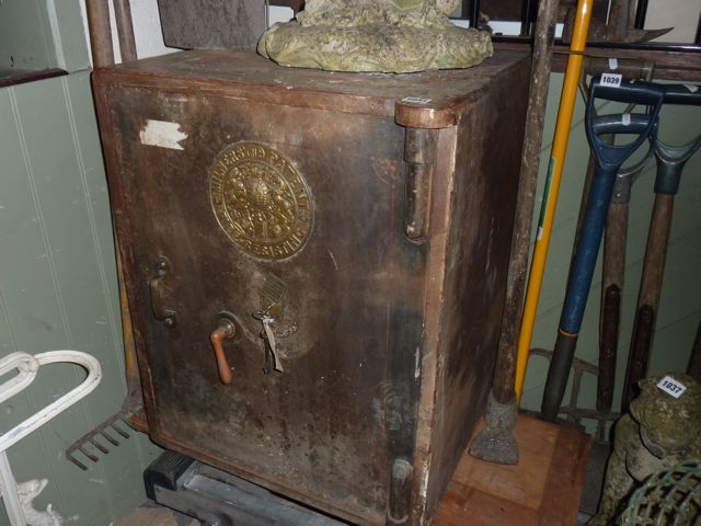 A large Milners patent fire resisting safe with circular embossed brass plate and partially fitted