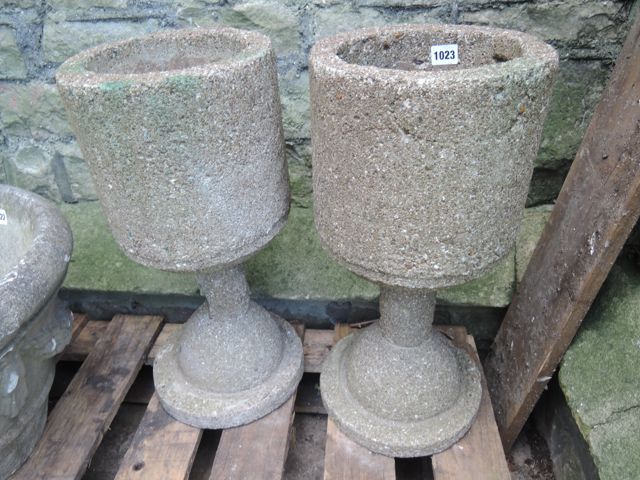 A pair of contemporary cast composition stone planters of unusual chalice shaped form